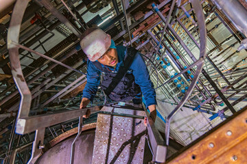 The topview male worker down the ladder is for inspection stainless steel tank