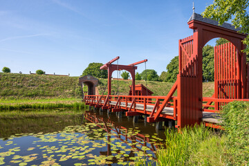 Red bridge over a moat in Bourtange, the Netherlands