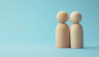 Two simple wooden figures standing close together