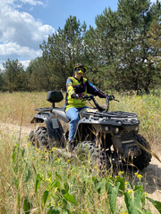 Quad bike ride on dirt roads in nature, vertical shooting