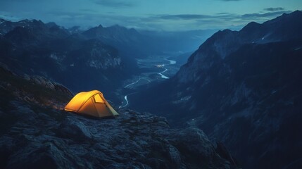 Illuminated tent glows on a rocky mountain ridge at night