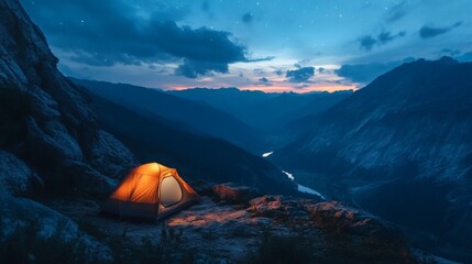Lit Camping Tent on Rocky Ledge Overlooking Mountain Valley at Night