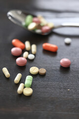 pills scattered on a dark background, medical topic dosage of medicine, concept of stress medicine