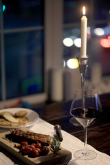 dinner in a restaurant with wine, beautiful table setting, a glass of wine in the foreground