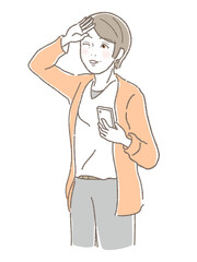 スマホを持ってまぶしそうにしている中高年女性