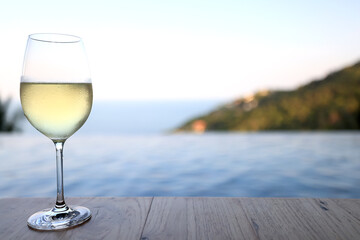 glass of cold white wine on the summer seashore by the water, relaxing by the water, a gentle background of soft color