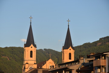Scenic Church Towers Against a Mountainous Background at Sunset