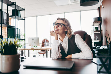 Confident businesswoman in a modern office environment with a stylish appearance and positive...