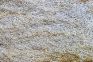 Natural stone texture with rough surface and uneven shades ideal for use as a background or design...