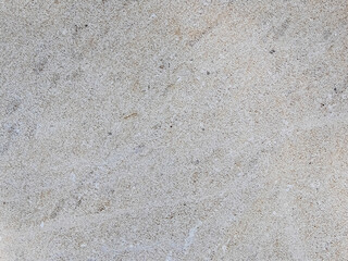 Light gray granular texture imitating asphalt or concrete surface ideal as background for graphic...