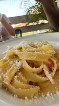 Enjoy the delicious Fettuccine Pasta, beautifully presented in a charming outdoor setting