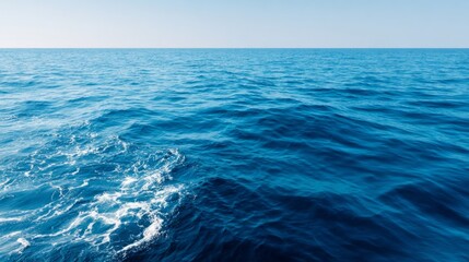 Fototapeta premium Endless Blue Horizon, a serene view of a vast ocean under a clear sky, featuring an expansive minimalist background that conveys tranquility and open space.