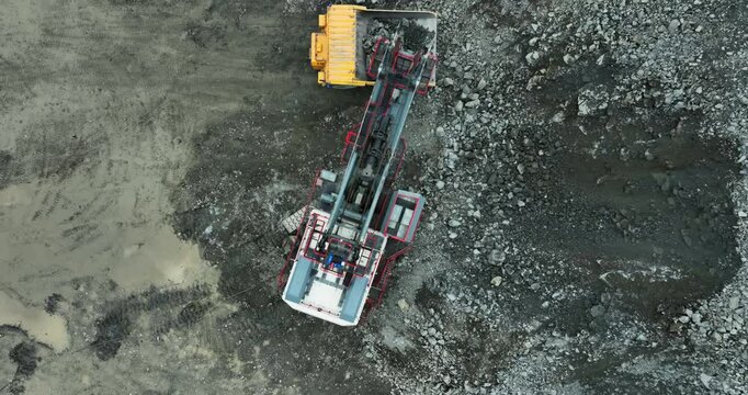 Heavy machinery processes rocks in open pit mining. Stock clip