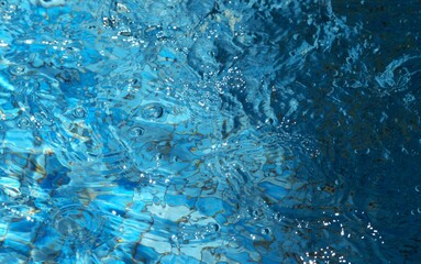 Blue transparent sea surface with bubbles water background