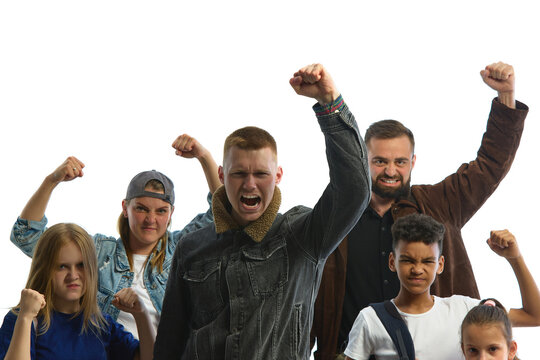 A diverse group stands united in protest, raising fists with determined expressions against a white background. Concept of economic crisis and migration trends.