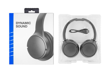 close up of black wireless stereo headphones, usb charging cable and paper box on white background