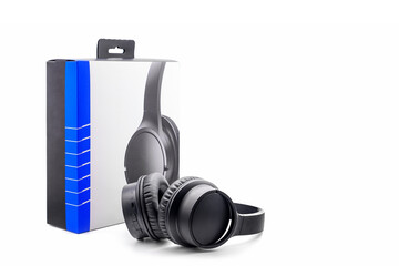 digital black wireless acoustic stereo headphones and packaging cardboard box on white background