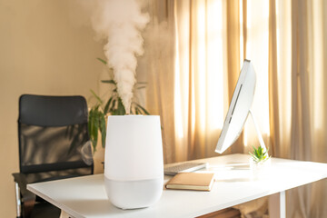 Office air freshener and humidifier releasing steam in a stylish workspace