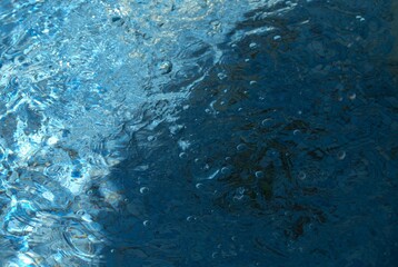 Blue transparent sea surface with bubbles water background