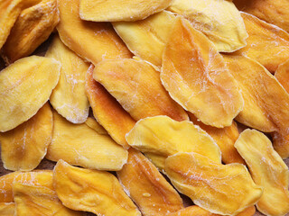 Dried mango on the market. Delicious sweet slices of dried mango background.