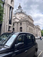 Classic London Taxi on Busy City Street, United Kingdom