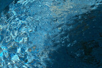 Blue transparent sea surface with bubbles water background