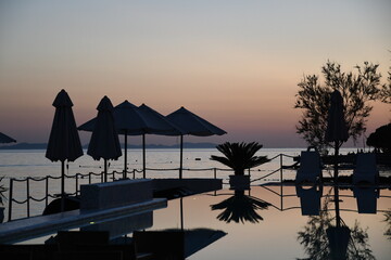 Tranquil Sunset by the Pool: Relaxation and Serenity at a Coasta