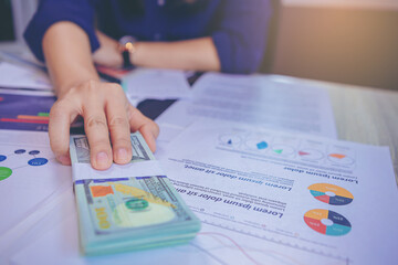 Businesswoman holding money banknotes and making decision for business investment. Selected focus