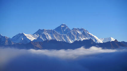 Majestic snow-capped Himalayan mountain range viewed from below, partially obscured by clouds under a clear blue sky