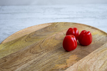 Tomatoes and Cherry tomatoes on a wooden tray