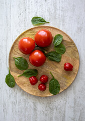Tomatoes and Cherry tomatoes on a wooden tray
