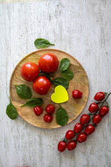 Tomatoes and Cherry tomatoes on a wooden tray