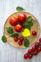Tomatoes and Cherry tomatoes on a wooden tray