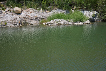 Mountain Stream with Rocky Shoreline and Water
