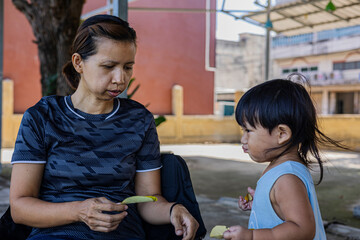 Toddler Collects Dry Leaves For His Mother