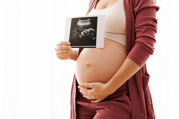 Closeup Shot Of Pregnant Lady Showing Baby Ultrasound Photo And Embracing Belly, Unrecognizable...