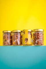 Colorful jars filled with granola displayed on a vibrant background