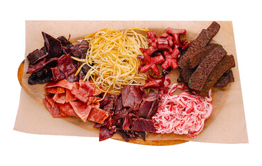 Assorted dried meats and noodles arranged on a serving board