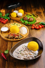 Colorful assortment of traditional dishes featuring polenta and meatballs