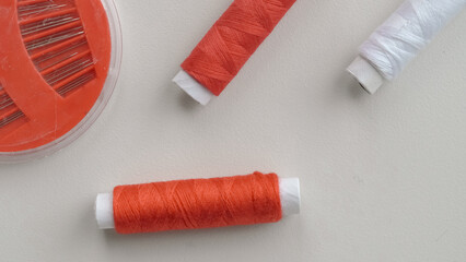 Thread spools in organizer with soft fabric on white background for sewing