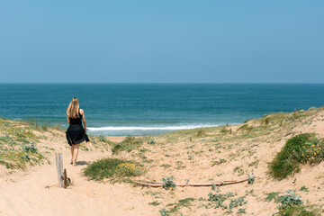 young woman walking on the beach