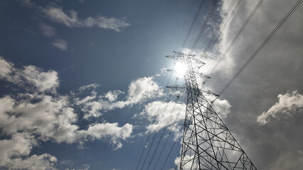 High voltage power tower Electrical pole structure blue sky background. Transmission energy cable line.