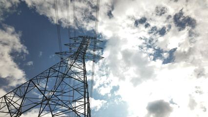High voltage power tower Electrical pole structure blue sky background. Transmission energy cable line.