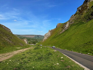 Panorama of narrow road passing through Winnats Pass in the Peak District, England, UK.