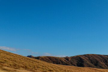 Tranquil Volcanic Plateau and Distant Mountain View on a Bright Cloudy Day