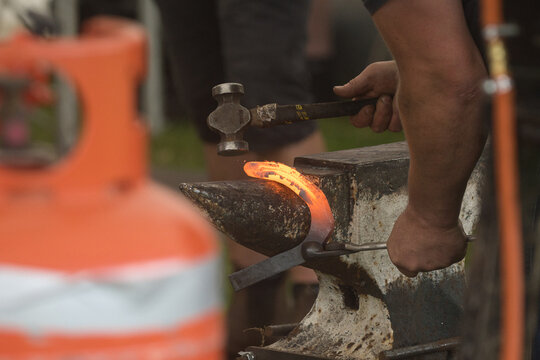 forging a horseshoe - Powered by Adobe