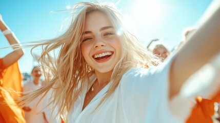 A joyful young woman is smiling brightly against the sun, embodying happiness and the joy of life, showcasing the beauty of carefree moments spent outdoors with friends.