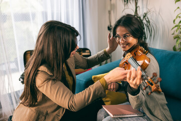 Music Teacher Teaching Student How To Hold Violin