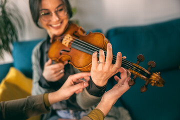 Music Teacher Teaching Student How To Hold Violin