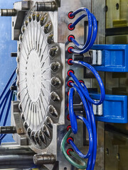 Plastic press machinery used in industrial manufacturing processes at a factory facility for producing various plastic components
